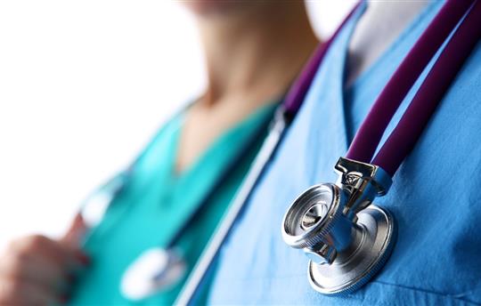 young doctor standing with a stethoscope on a white background
